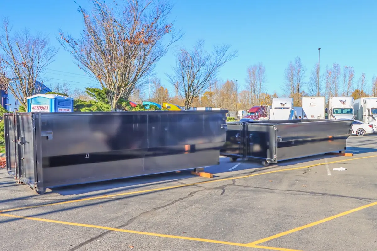 Professional dumpster rental service with roll-off container on residential driveway in Smyrna